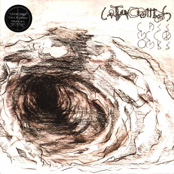 Allmusic album Review : On the album he released previous to 2009s Catacombs, Baltimore singer/songwriter Cass McCombs began moving away from the reverb-heavy, lo-fi sound and busy arrangements of his first two records in favor of a more direct sound with cleaner production. Here, McCombs strips away the remaining traces of his early bedroom-crafted indie pop sound and aims for something simpler that takes the focus away from the sound of the record and places it firmly on the wordy, emotionally charged songs and McCombs vocals. The vocals are always up to the task; McCombs has ditched the jittery yelping he sometimes used on Dropping the Writ and instead settles into a warm and intimate style that instantly draws the listener in closer. The songs are mostly strong, too; almost uniformly quiet and introspective, they create a mood that lingers throughout the album like a melancholy haze. Tracks like the yearning "Dreams Come True Girl" or the tender, epic "Harmonia" cast a quietly desperate spell; in much the same way American Music Club did, only with less sarcastic wit and more resigned sadness. Only the lightly skipping "Prima Donna" breaks the feeling and adds some much-needed sunshine. The problem with creating an album this uniformly midtempo and hushed is that by the end, the listener may be screaming for a song to show some spunk or to kick the tempo up past the "lope" setting. It doesnt happen here, and its not really a big problem because the songs and mood are so cleverly established and sustained. The bigger issue is that a couple songs are overly wordy or hook-free ("Dont," "Lionkiller Got Married," and "My Sister, My Spouse"), and this is where the album could use some instrumental coloring or production tricks to add some much needed distraction. For the most part, though, the album is an enjoyable addition to McCombs catalog and shows him growing as an artist. While some fans of his early work may be left behind, most people who enjoy witty songs with tender emotion behind them will be satisfied with Catacombs and happy with the direction hes headed.