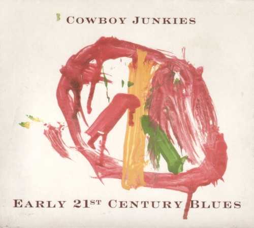 Allmusic album Review : Its been over 15 years since the Cowboy Junkies dropped their sparse masterpiece The Trinity Session. Recorded with very little gear in the span of one evening, it introduced the groups signature "sepia-drone" delivery to the world, a style thats never really undergone any surgery. Early 21st Century Blues attempts to build a bridge between 1988 and 2005 with a new collection of standards, covers, and originals that employ that same minimalist approach and scant recording time -- five days this time around. Built around the themes of "war, violence, fear, greed, ignorance, and loss," the familial quartet, along with a handful of friends, presents the works of Bob Dylan, John Lennon, Bruce Springsteen, Richie Havens, and U2 as filtered through the half-time heartbeat that is the Cowboy Junkies trademark. Anyone even remotely familiar with the group can look at a song like "One," "Isnt It a Pity," or "Two Soldiers" on paper and hear the version come to life in his or her head. All of the intimacy, heavy guitar reverb, smoky vocals, and snares kissed by brushes that fans have come to expect are here, rolling in like a harmless summer rain dressed in the dark clouds of a storm. The only exception, an awkward hip-hop version of Lennons "I Dont Want to Be a Soldier," featuring a rap by Kevin Bond (aka Rebel), is so out of place that its almost refreshing, rounding out a collection of reliable late-night jams that will appeal to the choir, but not the whole church.