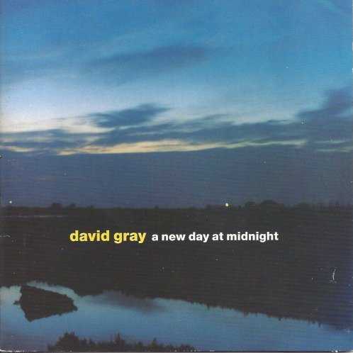 Allmusic album Review : David Grays 1999 release White Ladder was not only a chart hit around the globe but a career turnaround for the artist. His folky techno sound was refreshing and raw, and the public finally took notice to Grays honest approach. White Ladder went double platinum in America and earned Gray a Grammy nod for Best New Artist. Expectations for a follow-up were naturally high, and Gray wasted no time making another album. A New Day at Midnight, intermittently recorded between his spring 2001 tour and early fall, marks his sixth. He sticks with simple acoustics and subtle string arrangements; however, A New Day at Midnight doesnt possess the heavy heart of White Ladder. Perhaps Gray wasnt going for that, but fans were looking for an emotional disposition. The structure on this particular record is much more loose and carefree. What an impressive move for Gray, for he created something from his heart and mind without concerning himself or what was expected of him. The piano-driven "Meet Me on the Other Side" highlights personal reflections with grace. "Be Mine" is lyrically sweeter, but the winter chill of "December" ironically finds a peace of mind. Grays father passed away during the recording of A New Day at Midnight, so this is his swan song. The twinkling "Last Boat to America" offers classic White Ladder optimism, so Grays intent in making the lush and desirable more apparent is real. Grays definitely more introspective this time around, but hes less digital. Will fans appreciate that? Sure, but it will take some time.