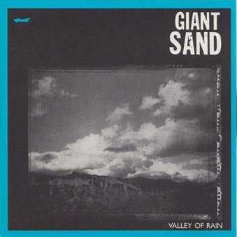 Allmusic album Review : The dry, dusty, and rambling sound that became Howe Gelbs trademark isnt much in evidence on Giant Sands debut album, 1985s Valley of Rain. Instead, this early edition of the band recalls the distaff branch of the Paisley Underground scene that was still a big part of the Los Angeles scene when Gelb arrived there from Tuscon, as if Giant Sand were the oddball high desert cousins of Green on Red. Valley of Rain is tougher and scrappier than much of what Giant Sand would release later on, and it rocks noticeably harder, though Gelbs sense of lyrical wanderlust is very much evident here, and even when the guitars wind up and the drums crack, the melodies drift on and off path with an expressive glee. The bands slightly warped country influences are all but invisible here (perhaps because Gelb and his pals were cutting a Blacky Ranchette album around the same time), and Valley of Rain sounds more sharply focused than the typical Giant Sand album. Gelb and his partners -- bassist Scott Garber and drummers Tom Larkins and Winston A. Watson, Jr. -- sound admirably tight and together, considering this lineup fell together at the last minute before these sessions began, and the album was recorded on the fly for a mere four hundred bucks. Valley of Rain isnt classic Giant Sand, but its a strong and confident starting point and it has weathered the test of time rather well: "Tumble and Tear," "Down on Town," and "Death, Dying and Channel 5" are forceful and idiosyncratic rockers, while "Artists" and "October, Anywhere" give a clue to where Giant Sand would go in the future. In a long journey full of fascinating detours along the way, Giant Sands first album was a rocking pit stop thats lively, smart, and full of nerve.