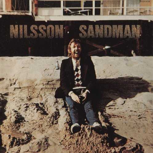 Allmusic album Review : Nilsson started going off the tracks at Pussy Cats, but his descent into sheer, unhinged lunacy became apparent with 1976s Sandman, his second album recorded in 1975. It was easy to view Duit on Mon Dei as transitory, but this proves that it was a transition to craziness and cultdom. At this point, he was abandoned by Lennon, left alone in L.A. and Nilsson just didnt care. He continued to roam, rampage, and record, ensconcing himself in his own world of in-jokes, Tin Pan Alley melodies, soft rock, clever wit, and sheer drunkenness. Check the cover: on the front, he has a bottle of wine between his legs, on the back hes overcome by a sand crab. On the album itself, he repudiates rock & roll, realizes "Pretty Soon Therell Be Nothing Left for Everybody," has a drunken conversation with himself (so extreme that hes thrown out of the bar), explains why he did not go to work today, writes an ode to flying saucers, offers cheekily literal instructions on how to write a song and then covers a song from the last album. Melodically, hes still strong, but the gleeful craziness overwhelms the pretty music and accessible production, resulting in an album that makes Son of Schmilsson and Pussy Cats seem normal, which may only signal just how far away from the mainstream Nilsson was at this point. But, in a way, he was still brilliant -- these are exceptional recordings, and his warped sense of humor is funnier than its ever been. Thats not to say that Sandman is an easy record -- you have to not only accept Nilssons quirks, but embrace them more than his talents to love this album -- but if your head is properly calibrated, this is one to treasure. [Originally released in 1976, Sandman was reissued with a bonus track in 2002.]