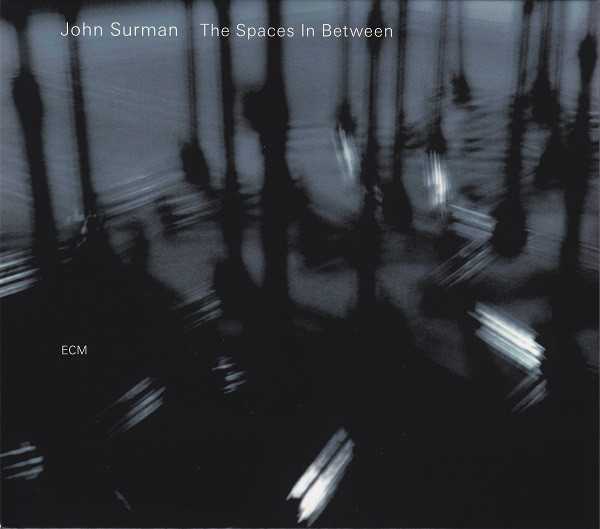 Allmusic album Review : Its been four long years since British composer and saxophonist John Surman issued a new recording for his longtime home label, ECM. In a loose way, The Spaces in Between is the mirror image of 2003s Free and Equal, recorded with drummer Jack DeJohnette and the London Brass (though that record was a mirror of the first teaming of Surman with his longtime collaborator, double bassist Chris Laurence and the then-new Trans4mation String Quartet). Surman has been writing, arranging for, and performing with Trans4mation since that time. Whereas Coruscating was far more formal in structure, and its textures and colorings plotted in advance, here there are more opportunities for the strings to improvise and add more freely to the mix. There is a beauty in this, as Surman revisits and reconstructs pieces that go all the way back to his Dawn years with the opening track "Moonlighter." Dont expect to be able to recognize this one from its former incarnation. The earlier band, in which John McLaughlin and Dave Holland played roles, was a much more fiery ensemble -- at a much louder volume -- for whom improvisation was the true prize. Here, the true treasure of the relatively spare melody Surman composed is worked from the ground up with restrained elegance by Transmation, and Laurences role is one of being a contrapuntal ballast for the saxophonist who plays baritone in a decidedly non post-Coltrane manner.<br><br> Other previously recorded Surman tunes are the lovely "Mimosa," written for the Thimar session trio with Anouar Brahem and Holland. The sheer old-world exoticism of the oud is here replaced by the slowly developing theme plucked out on the violin and then played in full by the quartet as Surman underscores those lines with short, melodic modal lines of his own, all of them resolving in passage. His soloing here is also far more engaging, allowing his own phrases to drift into one another with the end of one line suggesting the entrance of the next as Rita Mannings violin hovers and swoops in improvisation in the backdrop. Laurence enters a with a very compelling rhythm line that feels more like a solo setting, leaving Surman completely free to follow a different melodic path. In both pieces its easy to hear them dovetailing, complementing one another so well its almost as if the work was written in two distinct sections meant to be played one after another. The title cut is the hinge piece here, and occurs almost dead center. Its written as a solo violin work for Manning, and, at over eight minutes, is as striking a work as weve heard from Surman written for another instrument. Make no mistake, while there is improvisation involved here, this is a very tautly written work, where dynamic and tone demand as much control as the notes themselves. Surmans sense of space is singular. His lines are literally pregnant with meaning as they suggest not only themselves but reference other elements of both British folk traditions and its long, rich classical past while looking squarely at the 20th century and composers from Robert Simpson to Harold Truscott. What takes place after this gorgeous solo work is a much more active and lush, even bright sense of coloration and gorgeous harmonic structures to complement Surmans solos; his lovely and poetic soprano work on "Where Fortune Smiles" is a prime example, and the sprightly, paradigmatic "Leaving the Harrow," contains some of the most intricate work on the set. Its painterly in its movement, yet, at the same time suggests a look through memorys prism, the strings are so fluid and turn so quickly as Laurence plays a nearly knotty bass solo assisted by the rich, warm tonal clusters from the quartet at its beginning, and is left alone before Surman joins him for some rich and utterly lovely interplay before the strings re-enter in earnest, carrying with them the kind of drama that only the memory can illustrate. Surman may not record quite so regularly as he once did, but given how rich, varied, and thoroughly engaging and sumptuous this work is, we should perhaps celebrate the fact that we can savor his records rather than consume them.