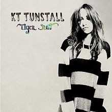 Allmusic album Review : Drastic Fantastic -- the spangly attempt at pop stardom consolidation -- didn’t catch on like it should have, but KT Tunstall doesn’t quite beat a retreat on its 2010 sequel, Tiger Suit. Sure, she’s reverted to contemplative photographs for her album art, but Tiger Suit isn’t a hermetically sealed sensitive singer/songwriter record, all quivering sincerity and strummed guitars. Fittingly for an album recorded at Berlin’s Hansa studio, where Achtung Baby and Heroes were cut, it is produced, polished, and textured, an album with movement and progression. Once the ominous opening chords to “Uummannaq Song” drift away, the song settles into a tight art-funk groove accentuated with folk shout-alongs, following no straight path to its conclusion. Tunstall takes no direct routes on Tiger Suit -- not when she slows tempos down, not when she recycles the “Black Horse and the Cherry Tree” rhythm for “Come on, Get In” -- but the twists that take her into the fuzzy glam-stomp of “Madame Trudeaux,” the whistled hook of “Glamour Puss,” the tight swirling circles of “Difficulty,” or the languid European blues of “Golden Frames” aren’t self-conscious stylizations, they’re lively and unexpected, colorful enough to grab upon first listen and rich enough to reveal layers upon repeats. As sonically pleasing as it is, Tiger Suit isn’t a mere vehicle for sound; it’s built upon Tunstall’s strongest set of songs yet, and it’s no coincidence that they’re her most ambitious, either: she may be firmly within the mainstream but she’s taking risks as a composer and record-maker, never settling into the role of the earnest earthbound folkie, winding up with an excellent album that satisfies as pure sound and as songwriting sustenance.