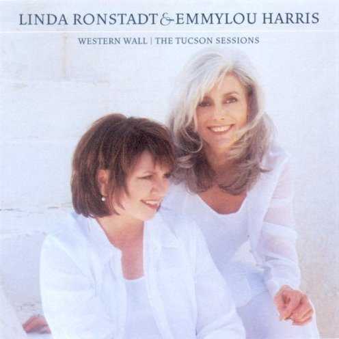 Allmusic album Review : Linda Ronstadt and Emmylou Harris have frequently collaborated over the course of their long careers. Their voices are made for each other in a yin-yang meeting of Ronstandts rich velvet alto and Harris songbird-sweet soprano. The Tucson Sessions takes their collaborations to new heights. A collection of covers and originals tracing various paths of love and loss, the performances seem to have breathed in the desert where they were recorded. Arrangements airy as the space between desert and sky are grounded by gritty guitars, splashed with color from folk instruments and filled with glorious harmonies. Well known singer/songwriters are covered -- Patty Griffin, Andy Prieboy, Rosanne Cash, Leonard Cohen, and Bruce Springsteen. Traditional presentations of Cohens "Sisters of Mercy" and Springsteens "Across the Border" take on new dimensions as sung by women. The spare arrangement and delicate harmonies lend a wonderful wistfulness to Cashs "Western Wall." A surprising cover choice with beautiful results is Sinead OConnors "This Is to Mother You." The albums best track, "1917," was written by folk singer David Olney. Its impossible to imagine anyone else singing this haunting tale of soldiers and women in WWI. Fragile and breathtaking, Harris voice is buoyed by the angelic harmonies of Ronstadt and Kate and Anna McGarrigle. Harris also contributes, along with some collaborators, three tracks to the album, notably the spirited "Raise the Dead."