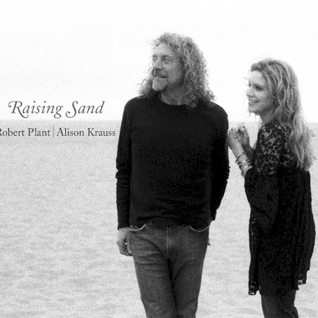 Allmusic album Review : What seems to be an unlikely pairing of former Led Zeppelin vocalist Robert Plant and bluegrass superstar Alison Krauss is actually one of the most effortless-sounding duos in modern popular music. The bridge seems to be producer T-Bone Burnett and the band assembled for this outing: drummer Jay Bellerose (who seems to be the session drummer in demand these days), upright bassist Dennis Crouch, guitarists Marc Ribot and Burnett, with Greg Leisz playing steel here and there, and a number of other guest appearances. Krauss, a monster fiddle player, only does so on two songs here. The proceedings are, predictably, very laid-back. Burnett has only known one speed these last ten years, and so the material chosen by the three is mostly very subdued. This doesnt make it boring, despite Burnetts production, which has become utterly predictable since he started working with Gillian Welch. He has a "sound" in the same way Daniel Lanois does: its edges are all rounded, everything is very warm, and it all sounds artificially dated. Sam Phillips "Sister Rosetta Goes Before Us" is a centerpiece on this set. It has her fingerprints all over it. This tune, with its forlorn, percussion-heavy tarantella backdrop, might have come from a Tom Waits record were it not so intricately melodic -- and Krauss gypsy swing fiddle is a gorgeous touch. There is an emptiness at the heart of longing particularly suited to Krauss woodsy voice, and Plants harmony vocal is perfect, understated yet ever-present. Its the most organically atmospheric tune on the set -- not in terms of production, but for lyric and compositional content. Stellar.<br><br> Plants own obsession with old rockabilly and blues tunes is satisfied on the sets opener, "Rich Woman," by Dorothy LaBostrie and McKinley Miller. Its all swamp, all past midnight, all gigolo boasting. Krauss harmony vocal underscores Plants low-key crooned boast as a mirror, as the person being used and who cant help it. Rollie Salleys "Killing the Blues" is all cough syrup guitars, muffled tom toms, and played-in-bedroom atmospherics. Nonetheless, the two vocalists make a brilliant song come to life with their shared sorrow, and its as if the meaning in the tune actually happens from the bitter irony in the space between the two vocalists as the whine of Leiszs steel roots this country song in the earth, not in the white clouds reflected in its refrain. There are a pair of Gene Clark tunes here as well. Plant is a Clark fan, and so its not a surprise, but the choices are: "Polly Come Home" and "Through the Morning, Through the Night" come from the second Dillard & Clark album from 1969 with the same title as the latter track. The first is a haunting ballad done in an old-world folk style that Clark would have been proud of. It reflects the same spirit and character as his own White Light album, but with Plant and Krauss, the spirit of Celtic-cum-Appalachian style that influenced bluegrass, and the Delta blues that influenced rock, are breached. "Through the Morning, Through the Night" is a wasted country love song told from the point of view of an outlaw. Plant gets his chance to rock -- a bit -- in the Everly Brothers "Gone Gone Gone (Done Moved On)." While it sounds nothing like the original, Plants pipes get to croon and drift over the distorted guitars and a clipped snare; he gets to do his trademark blues improv bit between verses. To be honest, it feels like it was tossed off and, therefore, less studied than anything else here: its a refreshing change of pace near the middle of the disc. It "rocks" in a roots way.<br><br> "Please Read the Letter" is written by Plant, Page Charlie Jones, and Michael Lee. Slow, plodding, almost crawling, Krauss harmony vocal takes it to the next step, adds the kind of lonesome depth that makes this a song whispered under a starless sky rather than just another lost love song. Waits and Kathleen Brennans "Trampled Rose," done shotgun ballad style, is, with the Phillips tune, the most beautiful thing here. Krauss near the top of her range sighs into the rhythm. Patrick Warrens toy piano sounds more like a marimba, and his pump organ adds to the percussive nature of this wary hymn from the depths. When she sings "You never pay just once/To get the job done," this skeletal band swells. Ribots dobro sounds like a rickety banjo, and it stutters just ahead of the bass drum and tom toms in Belleroses kit. Naomi Nevilles "Fortune Teller" shows Burnett at his best as a producer. He lets Plants voice come falling out of his mouth, staggering and stuttering the rhythms so they feel like a combination of Delta blues, second-line New Orleans, and Congo Square drum walk. The guitar is nasty and distorted, and the brush touches with their metallic sheen are a nice complement to the bass drums. It doesnt rock; it struts and staggers on its way. Krauss wordless vocal in the background creates a nice space for that incessant series of rhythms to play to.<br><br> The next three tunes are cagey, even for this eclectic set: Mel Tillis awesome ballad "Stick with Me Baby" sounds more like Dion & the Belmonts on the street corner on cough syrup and meaning every word. There is no doo wop, just the sweet melody falling from the singers mouths like an incantation with an understated but pronounced rhythm section painting them singing together in front of a burning ash can. This little gem is followed by a reading of Townes Van Zandts "Nothin" done in twilight Led Zeppelin style. It doesnt rock either. It plods and drifts, and crawls. Krauss fiddle moans above the tambourine, indistinct and distorted; low-tuned electric guitars and the haunted, echoing banjo are a compelling move and rescue the melody from the sonic clutter -- no, sonic clutter is not a bad thing. The weirdest thing is that while its the loudest tune on the set, it features Norman Blake on acoustic guitar with Burnett. This is what singer/songwriter heavy metal must sound like. And it is oh-so-slow. The final part of the trilogy of the weird takes place on Little Milton Campbells "Let Your Loss Be Your Lesson," a jangly country rocker in the vein of Neil Young without the weight and creak of age hindering it. Krauss is such a fine singer, and she does her own Plant imitation here. She has his phrasing down, his slippery way of enunciating, and you can hear why this was such a great match-up. The band can play backbone slip rockabilly shuffle with their eyes closed and their hands tied behind their backs, and they do it here. Its a great moment before the close. The haunting, old-timey "Your Long Journey by A.D. and Rosa Lee Watson," with its autoharp (played by Mike Seeger no less), Riley Baugus banjo, Crouchs big wooden bass, and Blakes acoustic guitar, is a whispering way to send this set of broken love songs off into the night. These two voices meld together seamlessly; they will not be swallowed even when the production is bigger than the song. They dont soar, they dont roar, they simply sing songs that offer different shades of meaning as a result of this welcome collaboration.