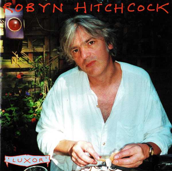 Allmusic album Review : Some of Robyn Hitchcocks best work in his career has been on his solo acoustic albums. It therefore comes as no surprise that Luxor is on par with both Eye and the classic I Often Dream of Trains, although it is a bit darker in tone than either of those discs. This collection offers more examples of Hitchcocks winning mix of silly and sublime lyrics backed with exotically tuned acoustic guitars. Numbers such as "The Sound of Sound," "Round Song," and "One L" are familiar and fresh all at once, as Hitchcock subtly rewrites variations of his own catalog. There is not only a strong sense of his own musical past evident, but also the past of pop music in general; sort of like a musical tea party with the ghosts of Syd Barrett, John Lennon, and Bob Dylan as the special guests. Once again, Hitchcocks amazing virtuosity on the guitar is highlighted with two instrumentals, including the title track, which is reminiscent of "The End," "Calvary Cross," and "White Summer." Hitchcocks tunefulness and playing have never really been in question, but the one nagging perplexity of his work that has perhaps kept him from greater fame has been his reputation for self-consciously bizarre lyrics. This aspect has been exaggerated to a great extent but there can sometimes be jarring juxtapositions inherent in some of his imagery. Hitchcocks vision has always included allusions to sex, death, vegetables, and small creatures, but to his credit hes never let that undermine his humanistic and hopeful side. But what do you make of an artist who sings "death is all around us like a swarm of bees, or maybe flies" and "everyone is fading gradually" in one breath, and then "I am not a yam!" and "Ill have your babies if youll have my cold" in the next one? Its akin to a philosophy professor who intermittently giggles to bring levity to some heavy theory. No matter, for Hitchcock is aging gracefully and still maturing artistically. Luxor is a minor gem in a catalog studded with jewels.