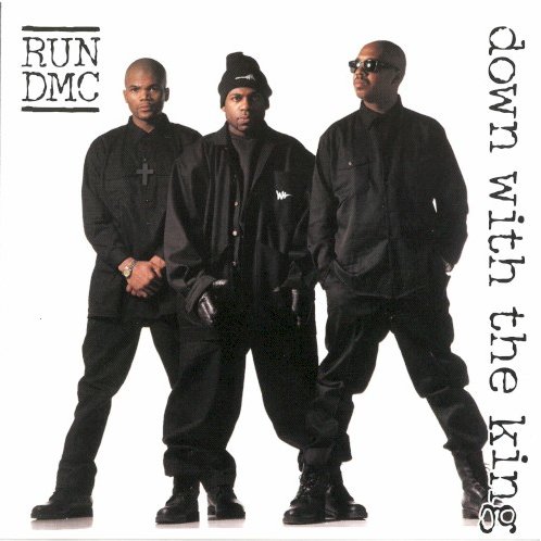 Allmusic album Review : After the poor response of Back from Hell, Run-D.M.C. decided to make some drastic changes. Their first point of order was to rebuild their dwindling street cred and reiterate their proven track record as the kings by compiling a best-of compilation. Simultaneously, they started work on a fresh and current-sounding album with the help of some of the hottest artists and producers in the rap game. Retreating from the funky new jack swing that overwhelmed Back from Hell, they enlisted Pete Rock, Q-Tip, EPMD, Naughty by Nature, the Bomb Squad, and Jermaine Dupri to help produce Down with the King. The new sound is decidedly more fashionable, and their fedoras and Adidas are abandoned here for bald heads and baggy black hoodies to match their new gangsta musical direction; which takes an obvious cue from Onyx (signed to Jam Master Jays label), whose "Slam" was a platinum hit earlier in 1993. Instead of using the intersecting back-and-forth wordplay that launched their career, this new incarnation of Run-D.M.C. incorporates the trendy "grimy" sound with ensemble shouts over specific lyrical parts (think Leaders of the New School). The beats are less corny, less funk-inspired, and more jazzy and sinister, with ominous basslines, organs, and delayed horn samples, and the vocals are more raucous and angry. Longtime fans will wonder why the trio isnt staying true to its past, especially when Run borrow from newcomers Das EFX with "stiggitys" and "riggitys," but the album serves its purpose of winning over a new generation of fans, and old-timers can find solace in the fact that rock is incorporated again in "Big Willie," a throwback to "Rock Box" with a rippin guitar part from Rage Against the Machines Tom Morello. While less original than their earlier classic albums, this is an impressive showing from a rap group thats been together ten years, and is pretty damn innovative in its own right.