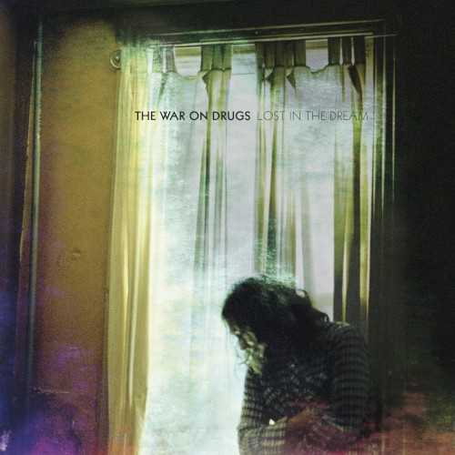 Allmusic album Review : When Philadelphia-based purveyors of stripped-down, haunted rock perfection the War on Drugs came on the scene with their 2008 debut, Wagonwheel Blues, their sound perked up the ears of a new generation of soul searchers looking for a soundtrack. Summoning up the patron saints of FM radio rock, the band was constantly framed as an update to the wild-eyed sermons of Dylan and Springsteen or the summer-night abandon that Tom Petty perfected, all filtered through walls of decidedly indie guitar noise. Founding member Kurt Vile left the band to pursue his blooming solo path by the time of 2011s Slave Ambient, leaving key songwriter Adam Granduciel running the show completely for that albums well-received set of songs and heightened production. Work on follow-up third album Lost in the Dream began while the band was on tour in 2012, with the full process of writing, demoing, and recording stretching out over a 15-month period and employing five different studios in as many states. Instead of resulting in a piecemeal pastiche of discordant ideas, Lost in the Dream actually represents the most fully realized statement from the group thus far, with all ten songs gelling together with a sense of purpose and understated brilliance the band came close to before, but delivers in full here. Starting with the epic two-chord gallop of "Under the Pressure," Granduciel offers up song after song of incredibly restrained yet entirely engaged rock. The classic rock reference points led to a "blue-collar rock" labeling of the bands sound, and while there are undeniable callbacks to Petty, Dylan, and Springsteen here, as there were on earlier albums, the War on Drugs have come into their own with their sound. What comes on as simplistic or even predictable rock instrumentation always unfolds to reveal buried synth sounds, horn blurts, long ambient passages, and -- more impressively -- an unexpected emotional depth propping up the bare-bones songs. While "Burning" channels the same yelping frustration and working-class trudge of Springsteens "Dancing in the Dark," songs like "Red Eyes" and the gorgeous "An Ocean in Between the Waves" meld Jackson Brownes inward-looking sensitivity and Fleetwood Mac-like mysteriousness with an edgy depravity belonging to Granduciel alone. The songs are expansive, regardless of their tone, with the ten tunes sprawling out into almost an hourlong running time, leaving no stone unturned in their nuanced production and deceptively simple presentation. In this way, Lost in the Dream is the War on Drugs Daydream Nation or Disintegration; lengthy distillations of similar themes result in wildly different threads of song, all connecting again in the end. Its a near flawless collection of dreamy vibes, shifting moods, and movement, and stands easily as Granduciels finest hour so far.